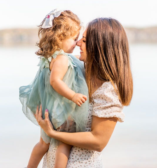 Mother and daughter touching noses.