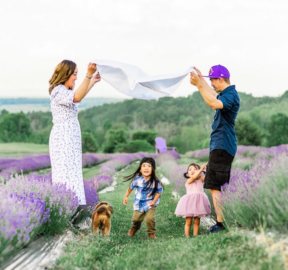 Couple playing with their two little children in a lavender field.