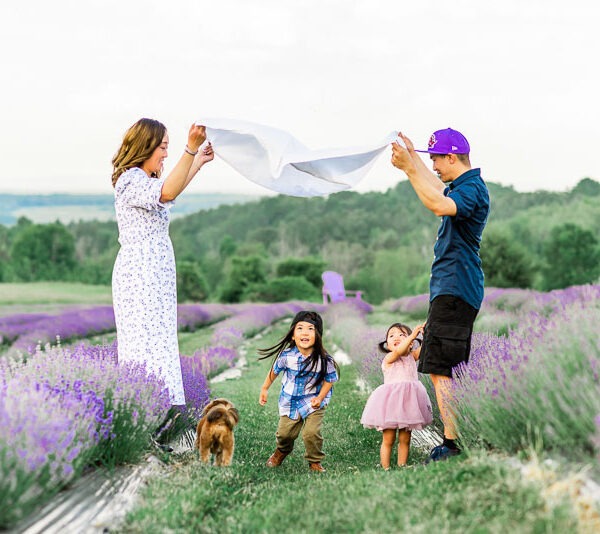 Couple playing with their two little children in a lavender field.